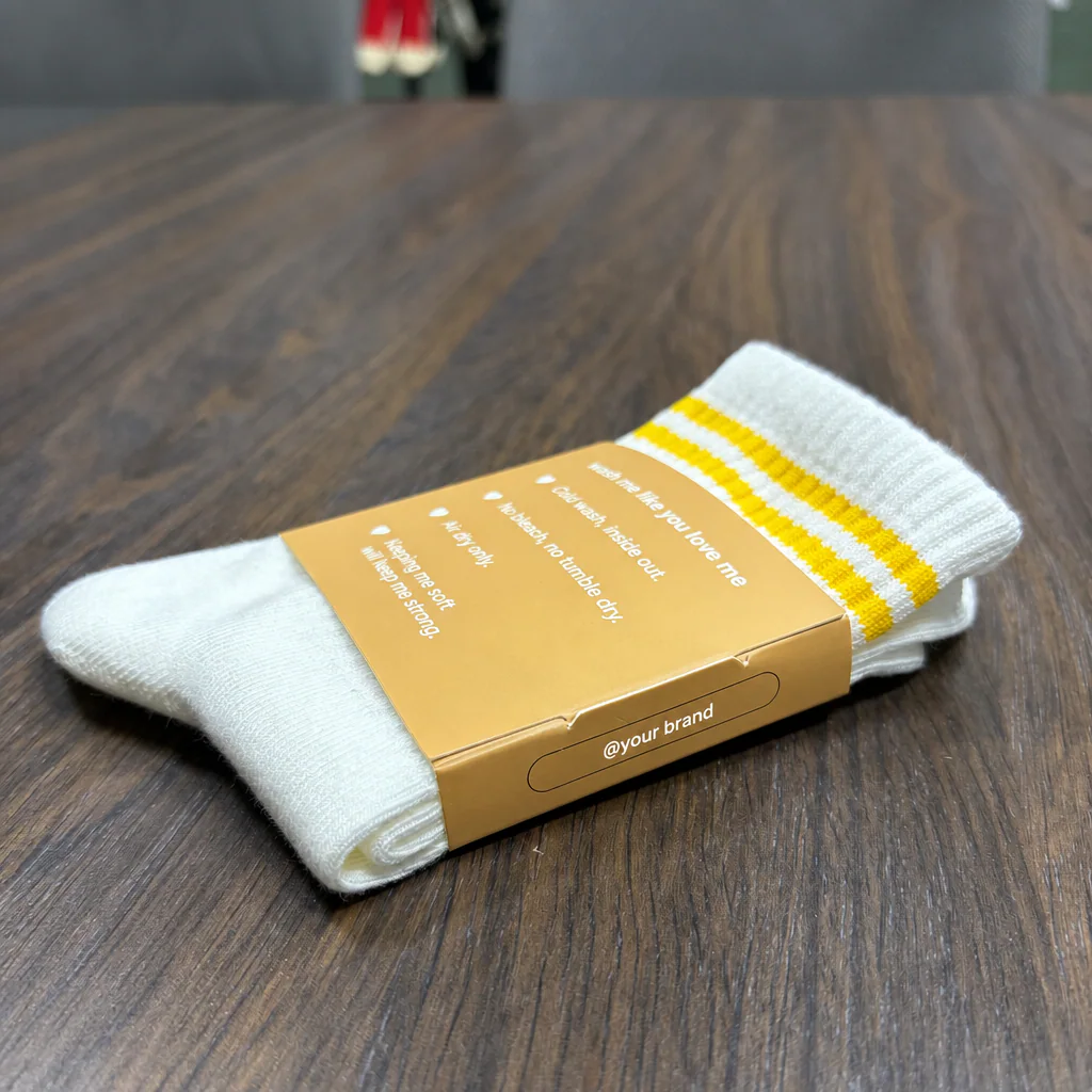 Side and care-information panels on a physical custom grip sock paper sleeve
