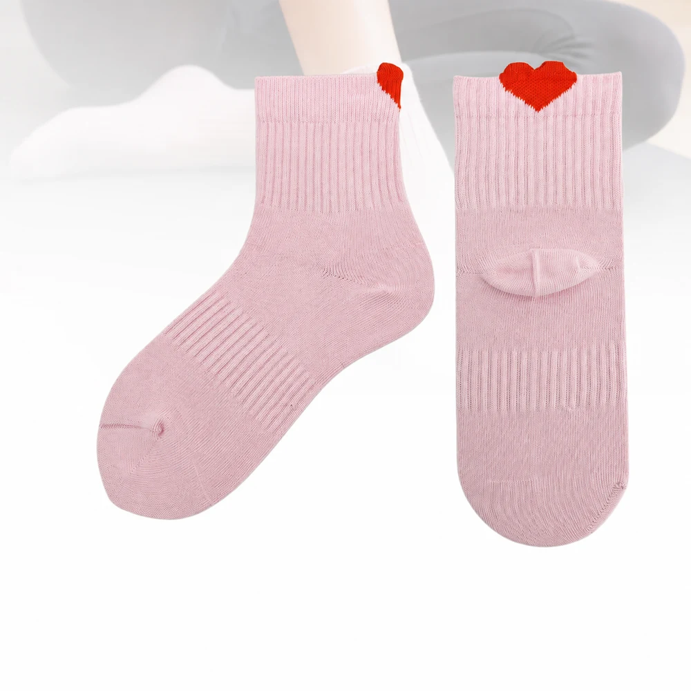 Pale-pink low-cut Pilates socks shown from front and back with a red heart-shaped jacquard cuff detail