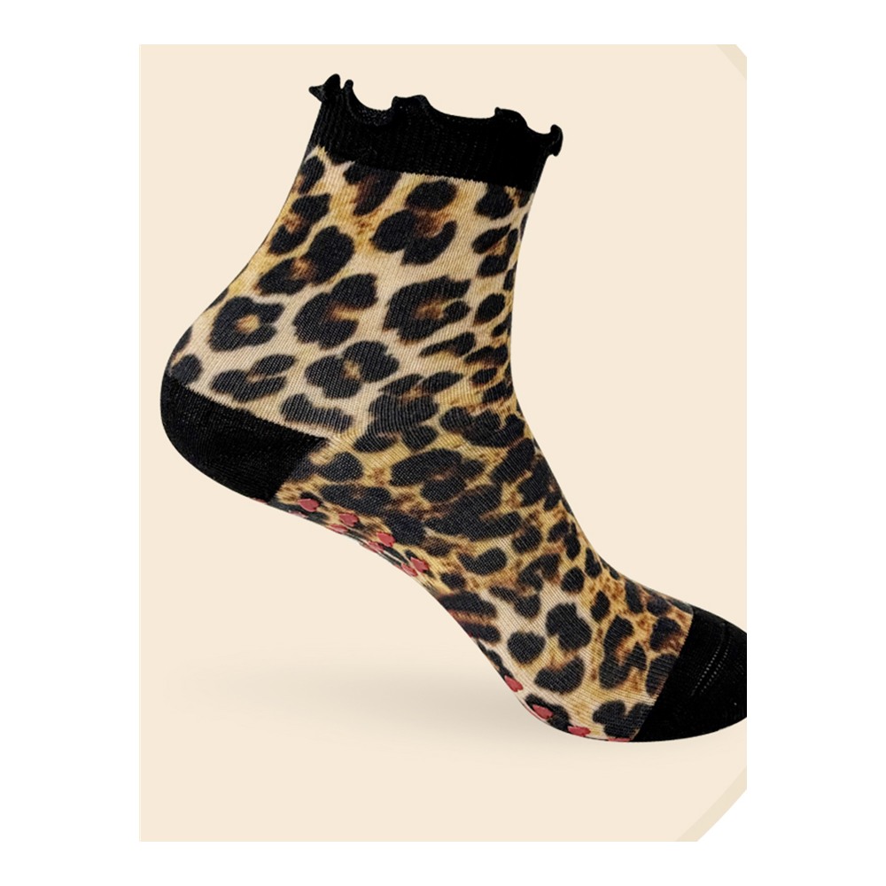 Leopard-print ankle Pilates grip sock with black ruffle cuff and visible red heart-shaped sole grips