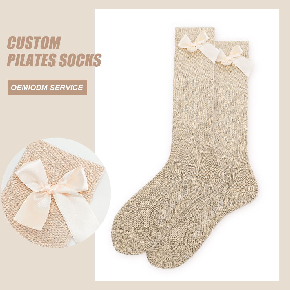 Original product image of beige high-crew Pilates socks with cream ribbon bows at the cuffs